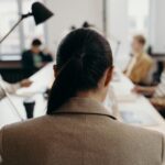 Diverse professionals collaborating in a modern office space, focused on teamwork and project management.